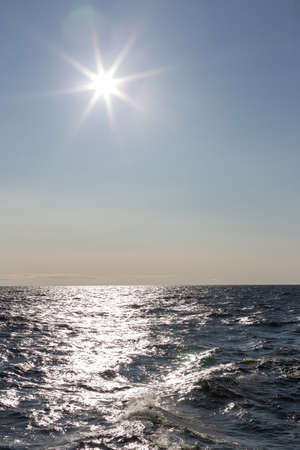 Sun in the sky over the seaの写真素材
