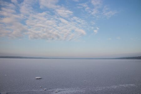 Winter landscape with lake and forestの写真素材