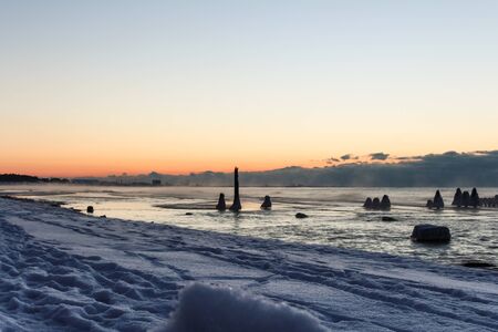 Pink tone of sunset on sky and old wooden pier