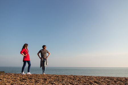Young couple standing at the beach in UK.の写真素材