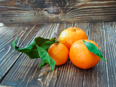 Fresh tangerines on wooden background, close upの写真素材
