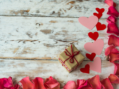 Blank valentine card with space for the text., scattered rose petals and gift, top viewの写真素材