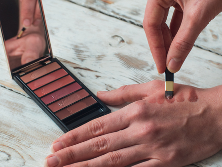 Woman holding a palette and brush, close up.の写真素材