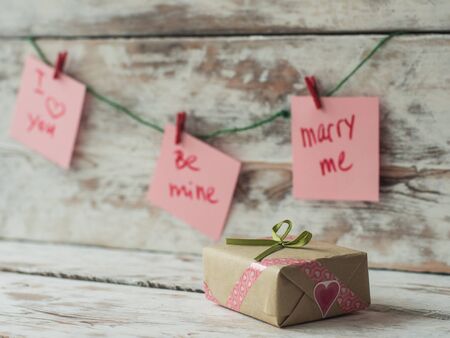 Valentines Day gift, greeting card on wooden background in vintage style. Space for textの写真素材
