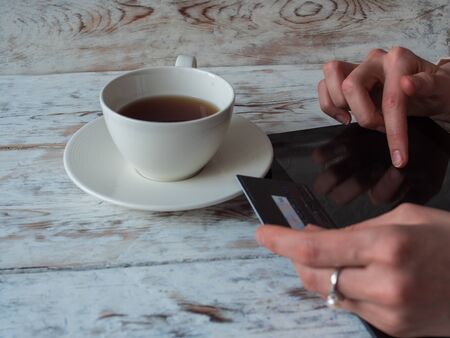 Woman shopping using tablet pc and credit card. close-up