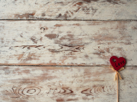Valentines day red heart on old wood. Holidays card with copy space.の写真素材