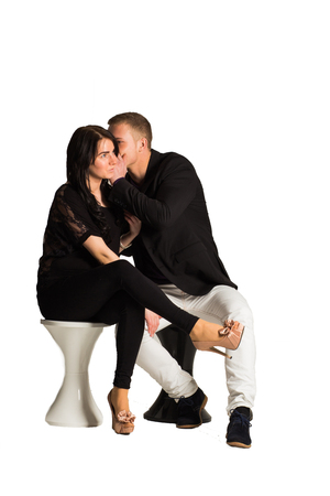Attractive man whispering and flirting with girlfriend.isolated on white background.の写真素材