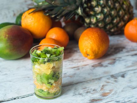 Diet concept on vintage board, fruit salad in a jar.の写真素材