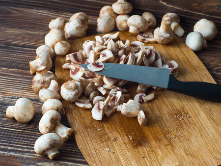 Top view of fresh organic mushrooms on chopping boardの写真素材