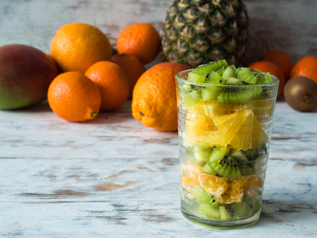 Colorful fruit salad in a jar on rustic wooden backgroundの写真素材