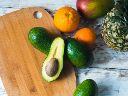 Top view of fruits on the table. Avocado, mango, pinnaple. Healthy food concept.の写真素材