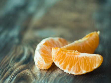 Fresh mandarines slices on wooden table, close upの写真素材