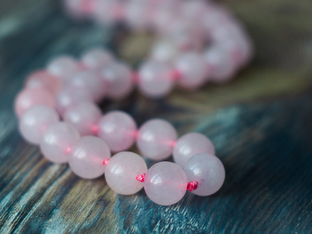 Elegant Pink quartz stone bracelet on old table. Close upの写真素材