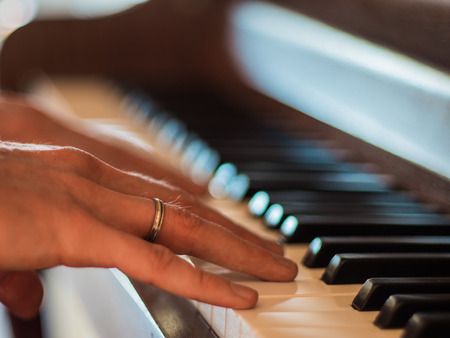 Close up of musician hands playing classic pianoの写真素材