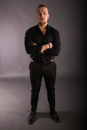 Portrait Of Satisfied Young Man Over Gray Background.の写真素材