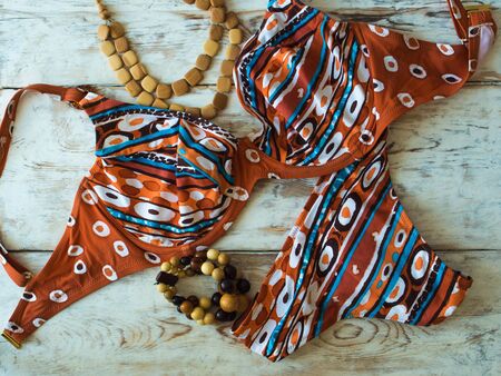 Beauty colorful womens bikini and accessories on wooden floor. Travel and holidays conceptの写真素材