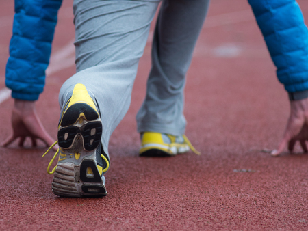 Closeup of man running shoes. male jogging at stadion.の写真素材