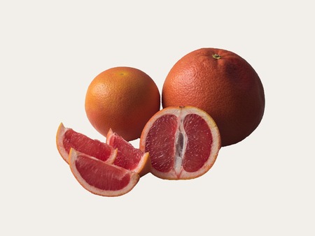 Fresh cut grapefruit with slices on a wooden table. Free space for textの写真素材