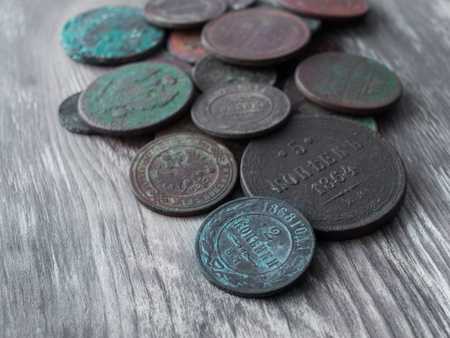 Coins on the background of old wood.の写真素材