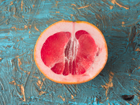 Top view on Organic Grapefruit slice on a old wooden table, top view.の写真素材