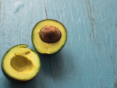 avocado slices on blue old table, side view with copy space.の写真素材