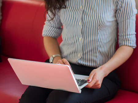 Close up womans hands using laptop indoorsの写真素材