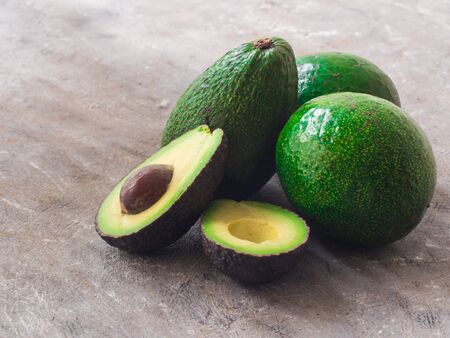 Fresh organic avocado on dark old wooden table, side viewの写真素材