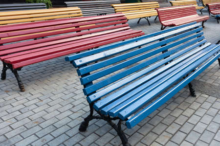 Free multicolored benches in the park in the summer day, close upの写真素材