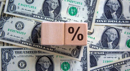 Wood cubes with percent sign on dollar background, copy space. Business concept.の写真素材