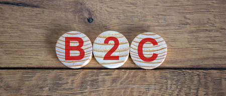'B2C' simbols on wooden alphabet circles. New normal concept. Beautiful wooden background.の写真素材