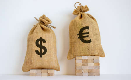 2 canvas bags with simbols of dollar and euro standing at different heights. Conceptual picture symbolizing cross currency exchange rates.の写真素材