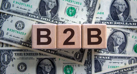 Concept word 'B2B' on cubes on a beautiful background from dollar bills.の写真素材