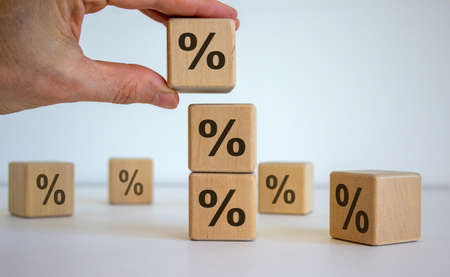 Man showing percent symbol on wooden cubes.の写真素材
