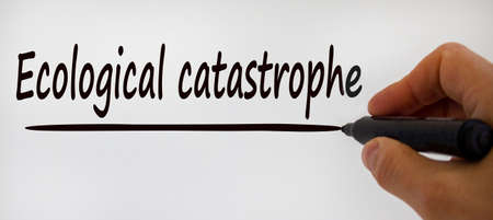 Hand writing 'ecological catastrophy', isolated on beautiful white background. Concept.の写真素材