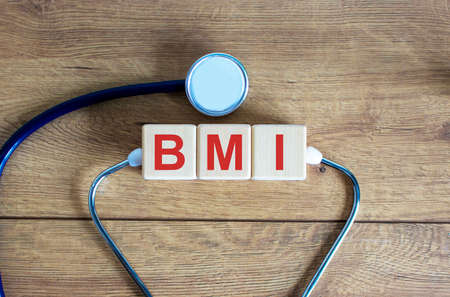 Medical concept. Wooden cubes with the inscription BMI and stethoscope.の写真素材