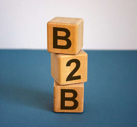 Concept text B2B on cubes on a beautiful blue background. Business concept.の写真素材