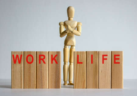 Wooden blocks with words 'work life'. Wooden model of human.の写真素材