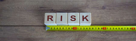 Risk Word On Blocks Arranged Behind The Ruler On Wooden Tableの写真素材
