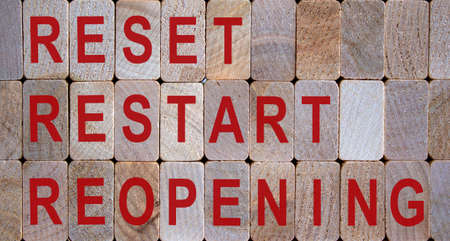 Wooden blocks form the words 'reset restart reopening'. Beautiful wooden background.の写真素材