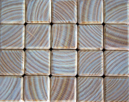 Photo of many small wooden cubes of different heights, tightly lying one after another, imitating the texture of the wallの写真素材