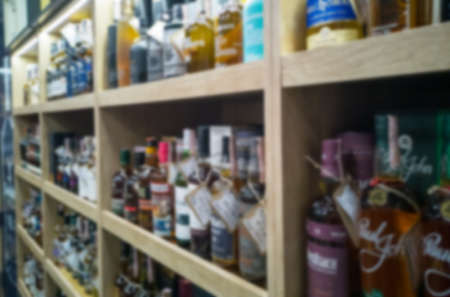 Blurred abstract background of shelf in supermarket. Alcohol showcase blurred background.の写真素材