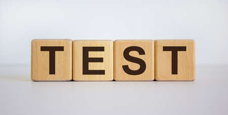 Wooden cubes with the inscription 'test'. Beautiful white background, copy space.の写真素材