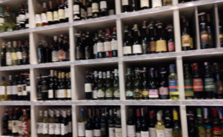 Concept blurred image. Alcohol showcase blurred background. Blurred abstract background of shelf in supermarketの写真素材