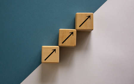 Business concept growth success process. Wood block stacking as step stair on paper blue and white background, copy space.の写真素材