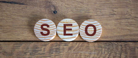 Concept word SEO on circles on a beautiful wooden table.の写真素材