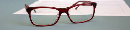 Glasses lying on the document. Image of the objects typical for business environment.の写真素材