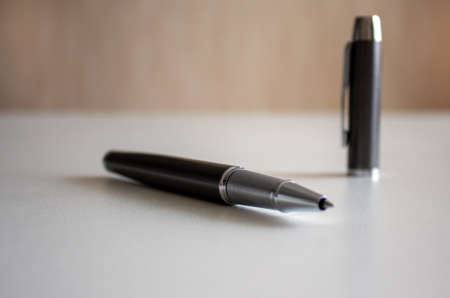 Pen on beautiful white fon. Cap in the background.の写真素材