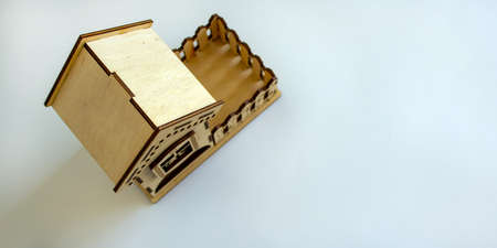 Wooden miniature house. Beautiful white background, copy space.の写真素材