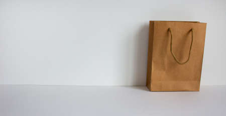 Disposable bag of kraft paper on a beautiful white background, copy space.