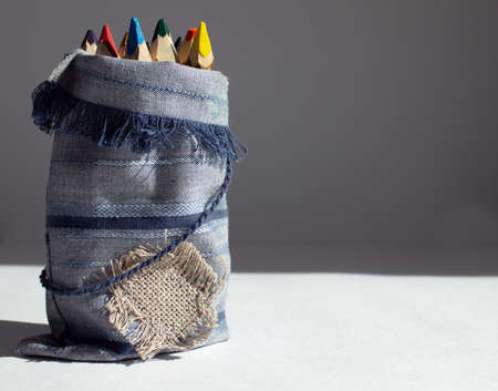 Wooden pencil on white background. Bunch of pencils stylized tree branch in bag. Warm sunlight.の写真素材
